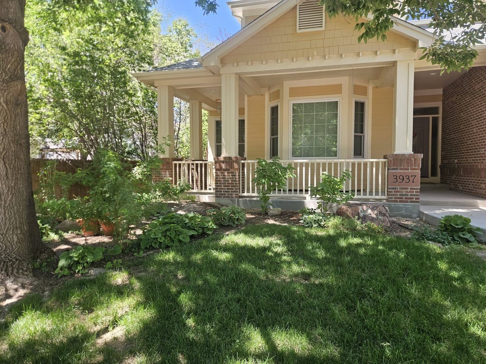 Front porch with white columns and railings
