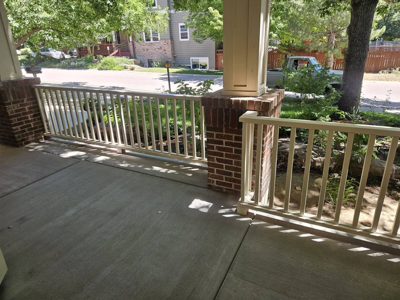 Covered porch with white and natural wood railings