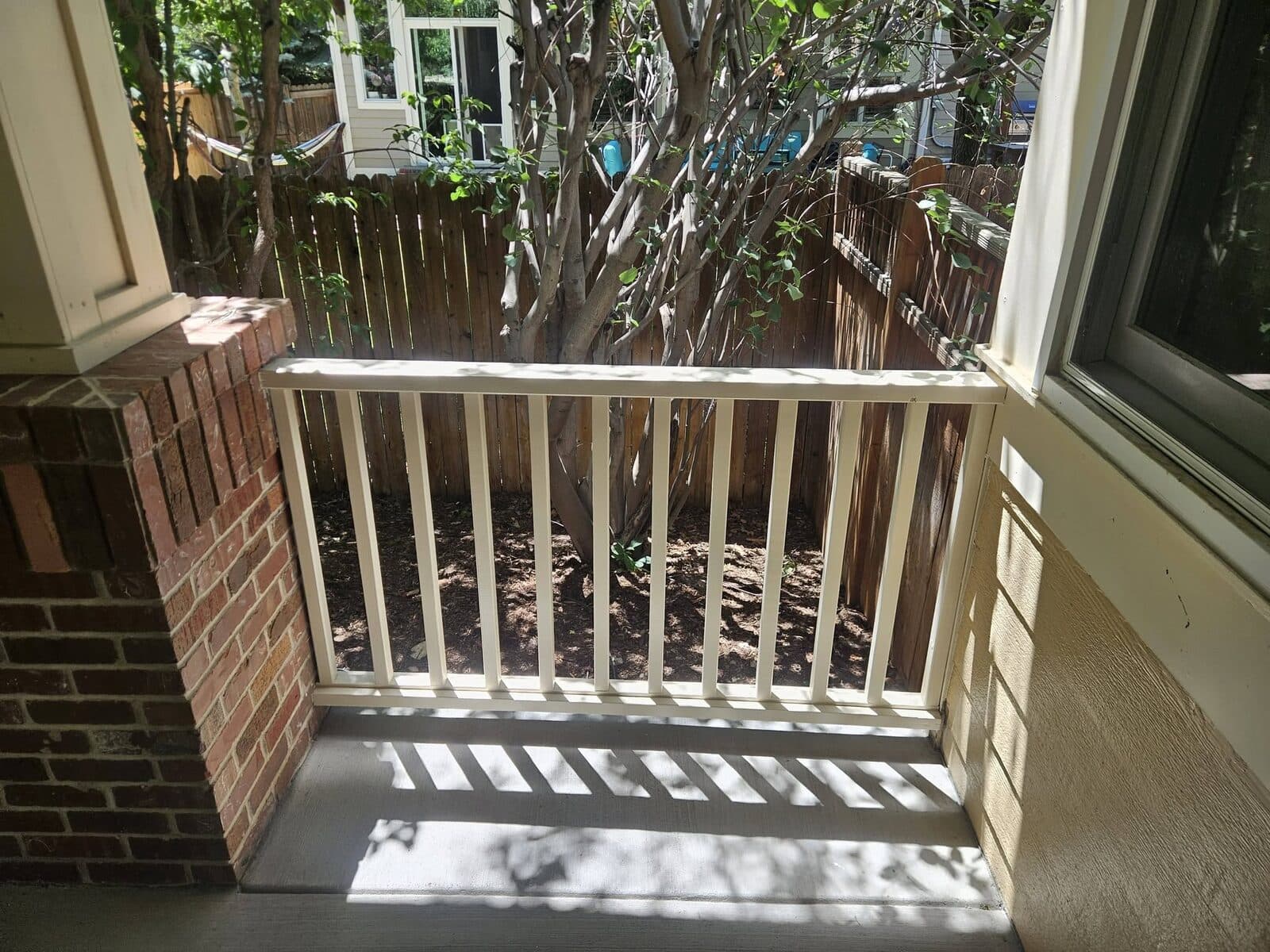 White deck railing with brick piers