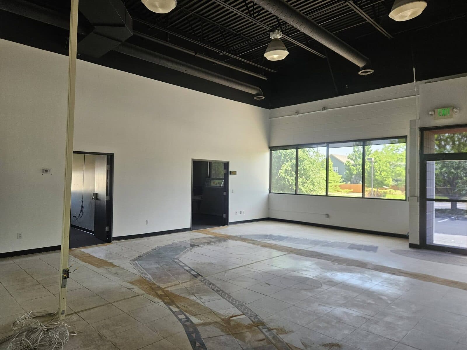 Finished commercial space with crisp white walls and a black ceiling