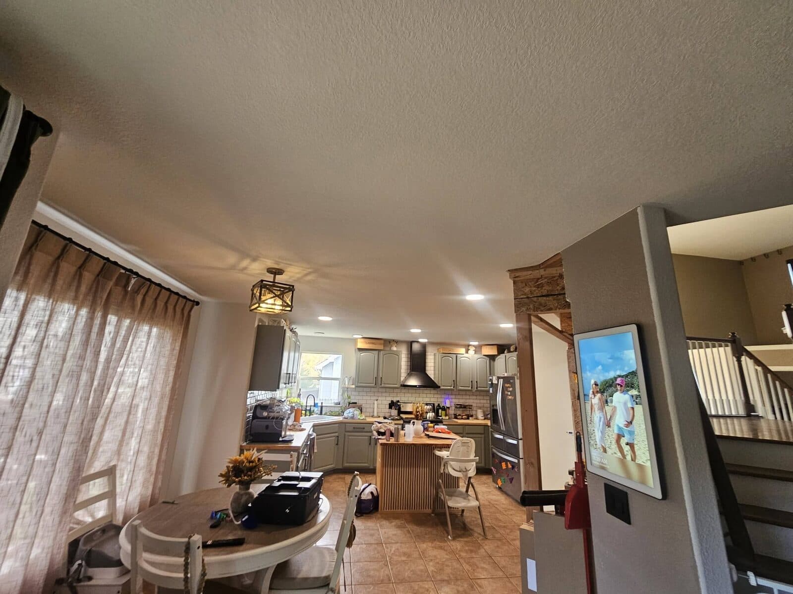 Open-concept kitchen and living area with painted ceiling
